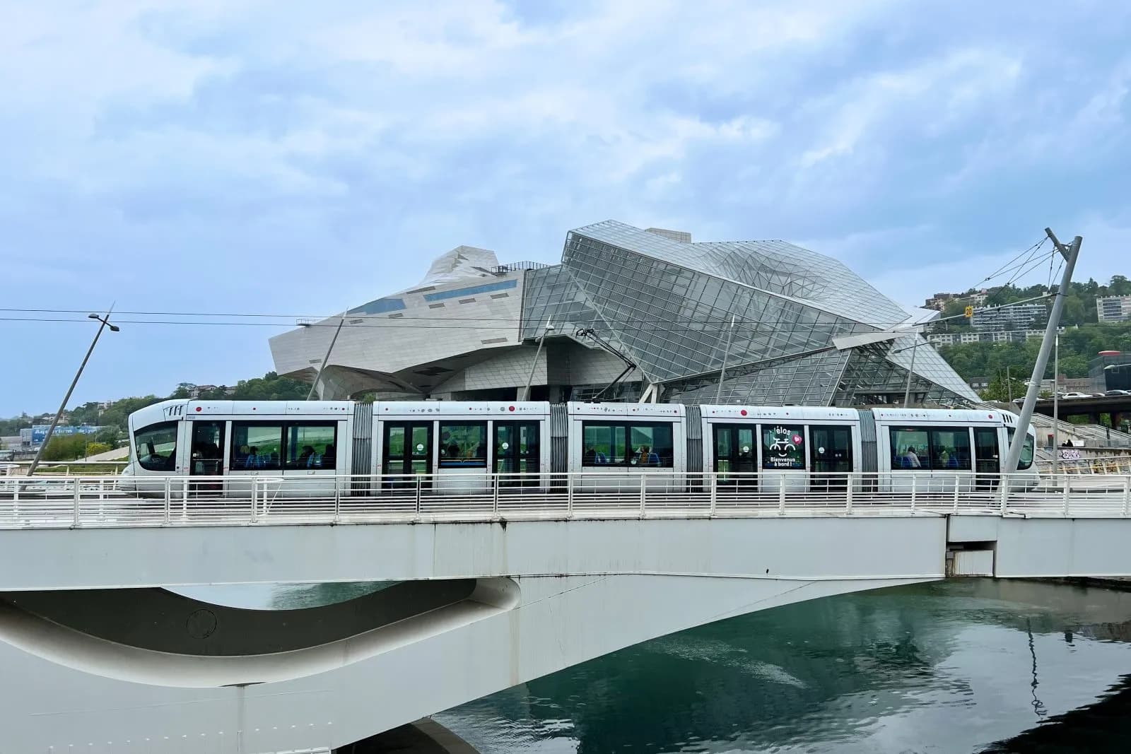 lyon-tram-with-coop-himmelbau-wolf-prix-building-shutterstock_2345917613-1600x1067